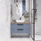 A Modern Floating Bathroom Vanity with Ribbed Blue Cabinetry, Neutral Countertop, and Elegant Vessel Sink Design