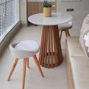 A Space For Unwinding And Entertaining Circular Wooden Table With Two Contemporary Stools